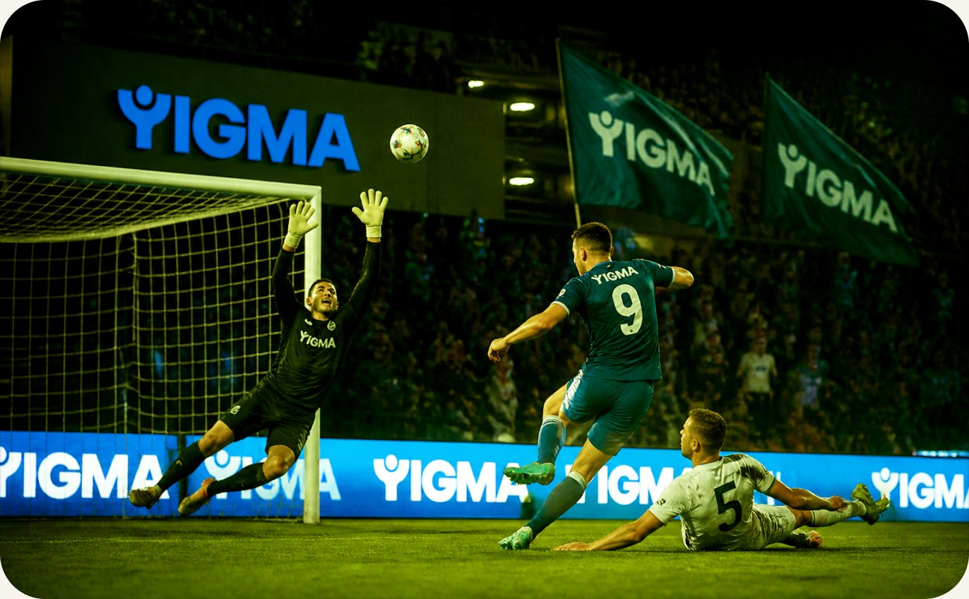 YIĞMA pitch-side branding and flags at a match